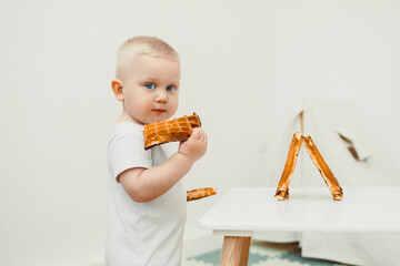A curious little toddler joyfully exploring playtime with an array of colorful building blocks in a...