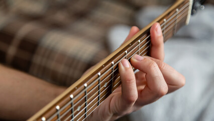 Guitar music. The performer plays. Practice chords. Male performer hands with fingers studying...