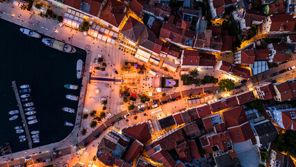Aerial view of Mali Lošinj (Losinj) at sunset. City lights begin to glow as the sun sets over the...