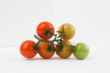Yellow, Red, and Green Tomatoes on White Background