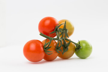 Yellow, Red, and Green Tomatoes on White Background