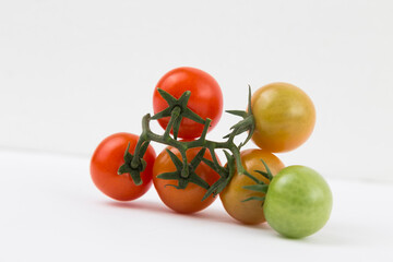 Yellow, Red, and Green Tomatoes on White Background