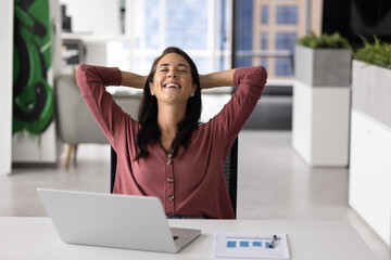 Paperwork is done. Portrait happy young businesswoman manager accountant relax at work desk recline...
