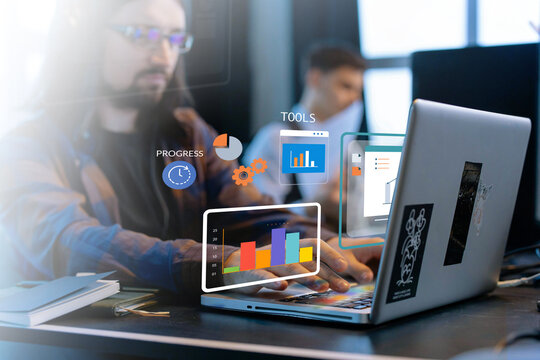 Programmer working on laptop with data visualization and progress tracking tools - Powered by Adobe