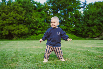 A Happy Toddler Joyfully Playing in the Grass  Creating Wonderful and Joyful Childhood Moments in...