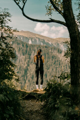 Girl Standing in Scenic Forest Landscape