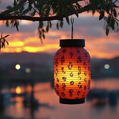 Sunset-lit, patterned paper lantern hanging from a tree branch