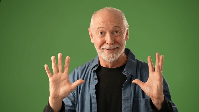 A senior man poses thoughtfully with fond memories, set against a green screen background, showcasing various emotions in a portrait setting that highlights his expressions. - Powered by Adobe