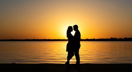 Couple Silhouette at Sunset Over Lake
