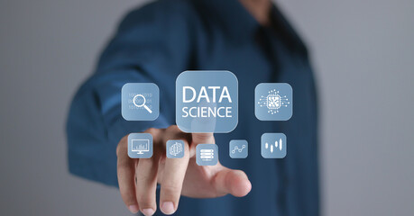 Data science and big data technology concept. Artificial intelligence, machine learning and business analytics. Person touching data science icons on virtual screen.