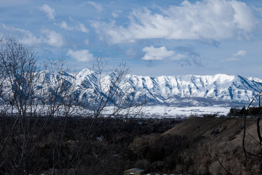 Mountains covered in snow under a blue sky - Powered by Adobe