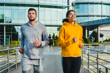 A group of friends exercises for cardio endurance, use a fitness watch and an app. Runners athletes...