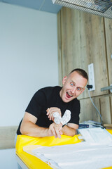 An enthusiastic man is fully engaged with his creative project while working in a modern and...