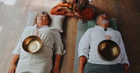 Tibetan bowl, meditation and energy with couple in studio for spiritual healing, aura cleanse and...