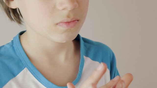 teenage boy applying acne cream, Teen boy focused on facial skincare, highlighting self-image issues and teenage skin concerns