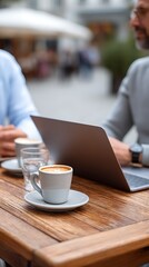Enjoying coffee break while working on a laptop outdoors.