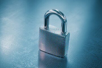 Fototapeta premium Close-up of metallic padlock on a blue background with binary code, symbolizing data security and digital protection