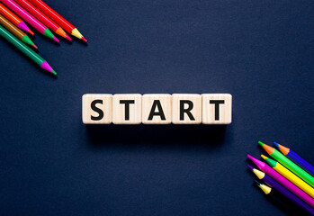 Start symbol. Concept word Start on beautiful wooden blocks. Beautiful black table black...