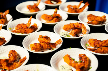Tempura shrimp before being offered as an appetizer at a luxury party