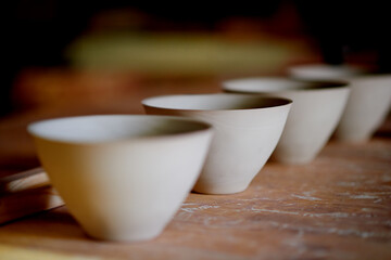 Handmade, ceramic and bowls for pottery on table for craft creation, creative manufacture and sculpture. Clay, diy and art product with artistic collection, crockery design and decoration at workshop