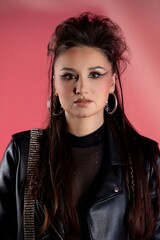 A Stylish Young Woman Showcasing Edgy Fashion While Sporting Dramatic and Bold Makeup