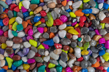 Collection of colorful shiny stones and pebbles in a variety of vibrant colors.
