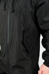Discover the stylish black windbreaker jacket that comes equipped with functional pockets, making it perfect for various outdoor activities while also keeping you looking fashionable and trendy © DSMT