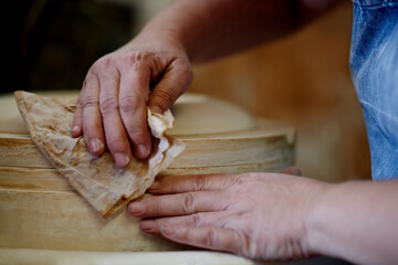 Cleaning, pottery and hands of person in studio ceramics product, manufacturing and project. Hobby,...