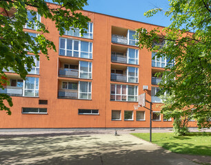 Residential Apartment Building With Orange Facade and Outdoor Basketball Court