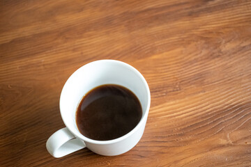 Brewing and pouring coffee with black french press on table in close-up