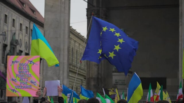 Munich. Germany. Odeonsplatz muenchen. Subject of war between Russia and Ukraine. Protesters holding yellow and blue and European Union flags at demonstration against war in Bayern. 
