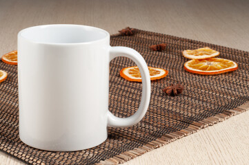 Blank 11oz white mug on on the table. Mugs with warm spices like cinnamon, star anise, dried orange. Mug mockup