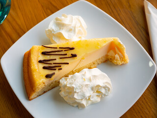 Piece of sweet delicious lemon cake with cream fondant blanc