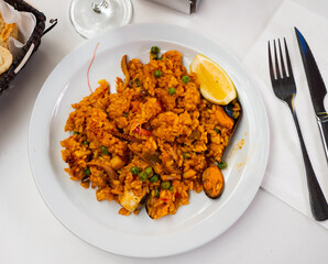 Popular Spanish dish is Paella with seafood, made from rice with saffron, mollusks and vegetables,...