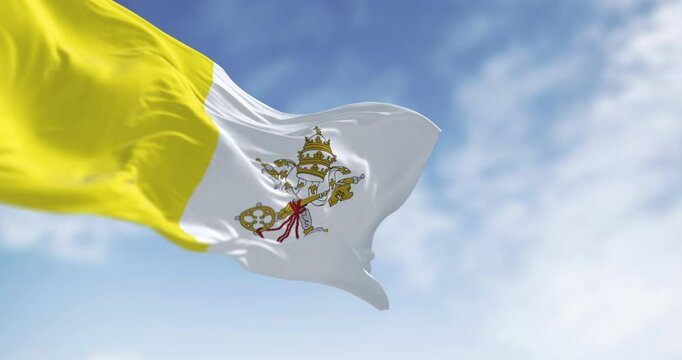 Flag of Vatican City waving in the wind on a clear day