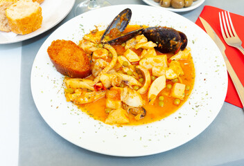 Tasty dish of spanish cuisine fried sepia with mussels in sauce, nobody