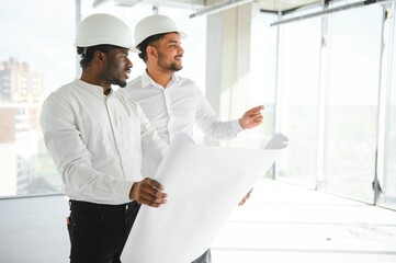 Indian and African American engineers at construction site