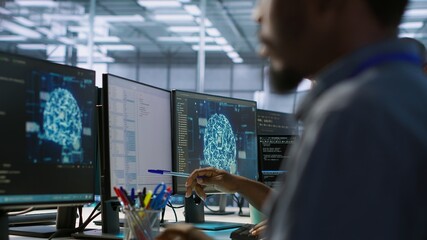 Machine learning expert in data center maintaining company network infrastructure. Worker using...