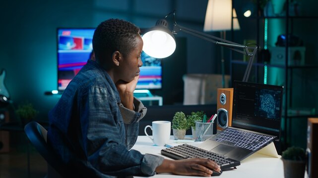 AI expert writes code on laptop in apartment office using Java programming languages. Artificial intelligence programmer remotely working on fixing database errors while working from home, camera A