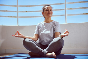 Woman Practicing Meditation Outdoors in Relaxed Setting for Mindful Wellness
