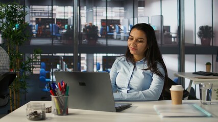 Indian businesswoman conducting a video call to review financial strategies with her colleagues....