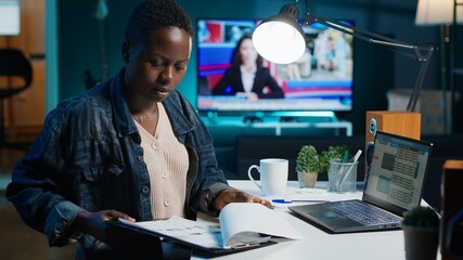Woman working from home preparing for business meeting looking at charts designing marketing...