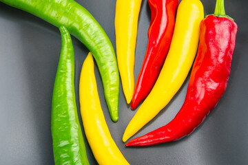 yellow, red and green hot chili on a plate. Pepper. Vegetable vitamin food.