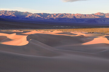 The first rays of the rising sun shine on the Sand Dunes and the distant Panamint Mountain range on this December morning
