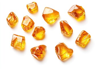 Golden, crystalline sugar crystals scattered on white background