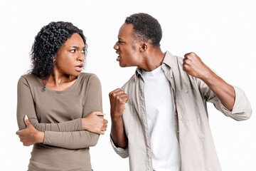 Domestic violence and abuse concept. Young african american mad man threatening his woman with his...