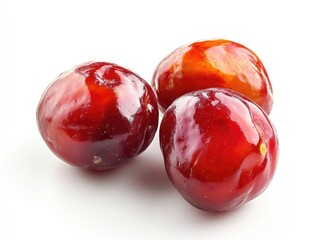 Obraz premium Three vibrant red plums close-up