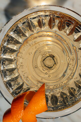 top down close up of carbonated wine cocktail with orange twist 