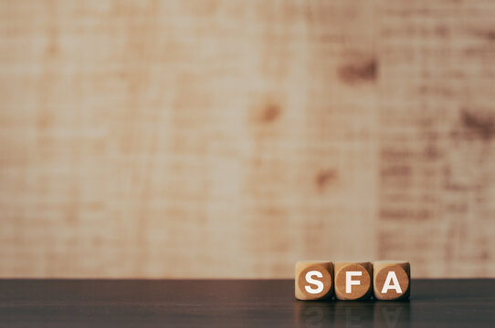 There is wood cube with the word SFA. It is an abbreviation for Sales Force Automation as eye-catching image.