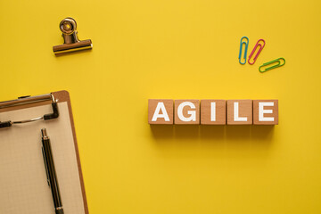 There is wood cube with the word AGILE. It is as an eye-catching image.
